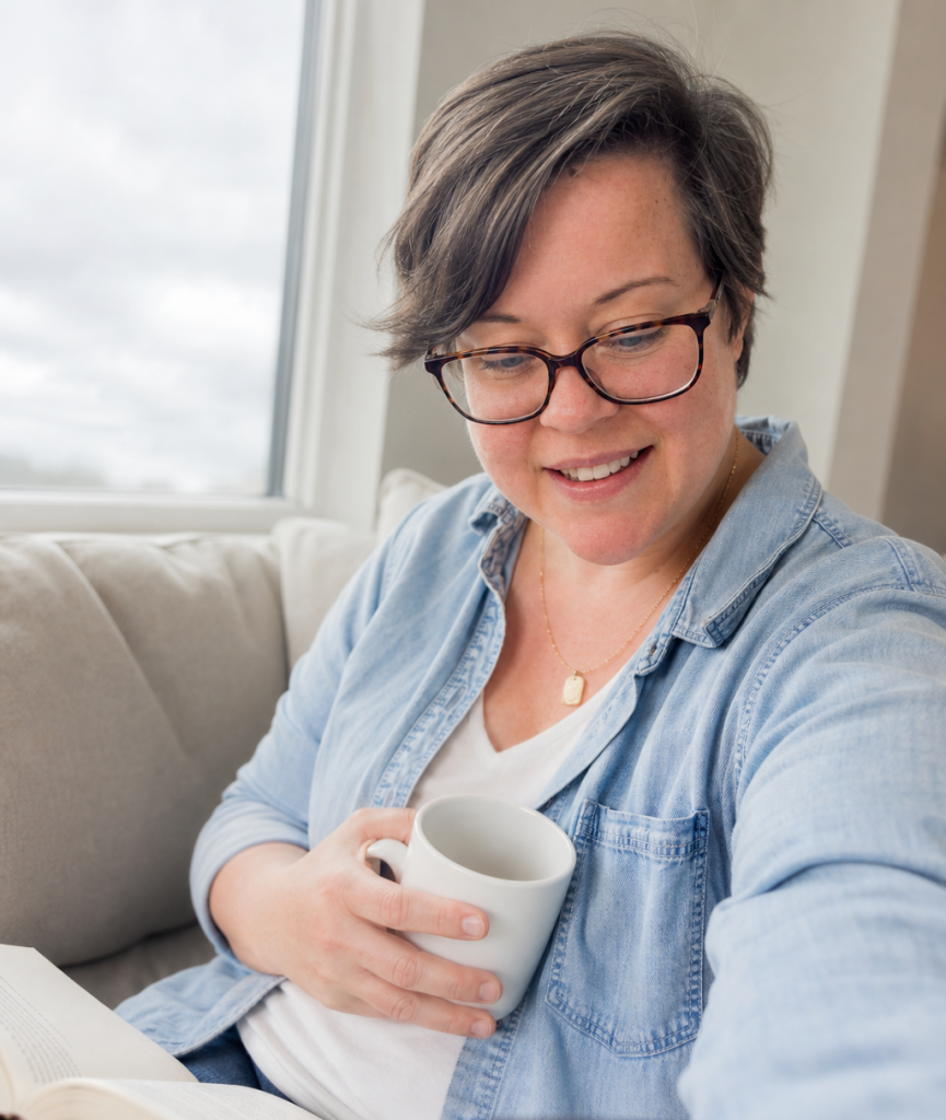 Bree Kibble, wedding designer in Wheeling WV, reading with a cup of coffee in hand.